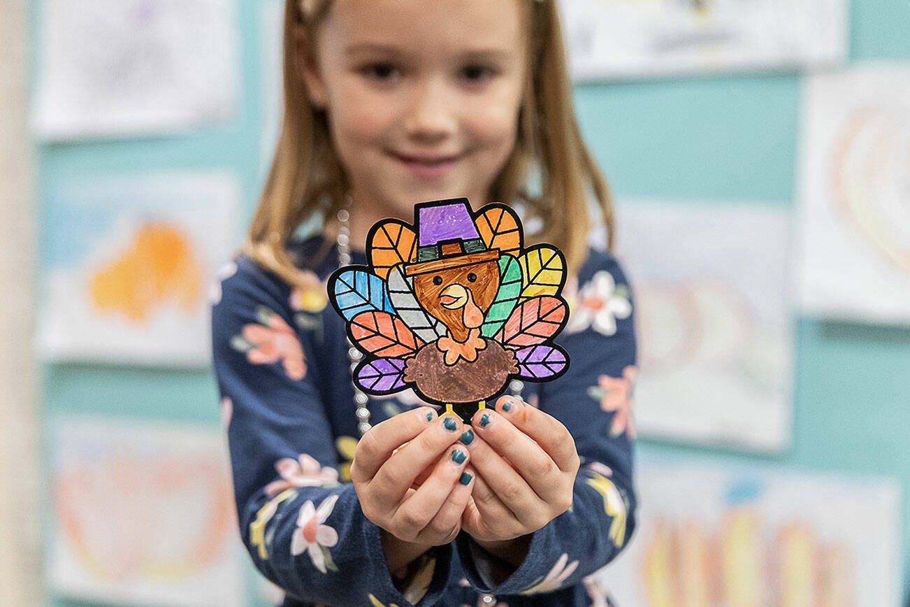 Blake Coleman, 5, shows off a turkey she colored at Highland Elementary on Tuesday, Nov. 26, 2024 in Lake Stevens, Washington. (Olivia Vanni / The Herald)