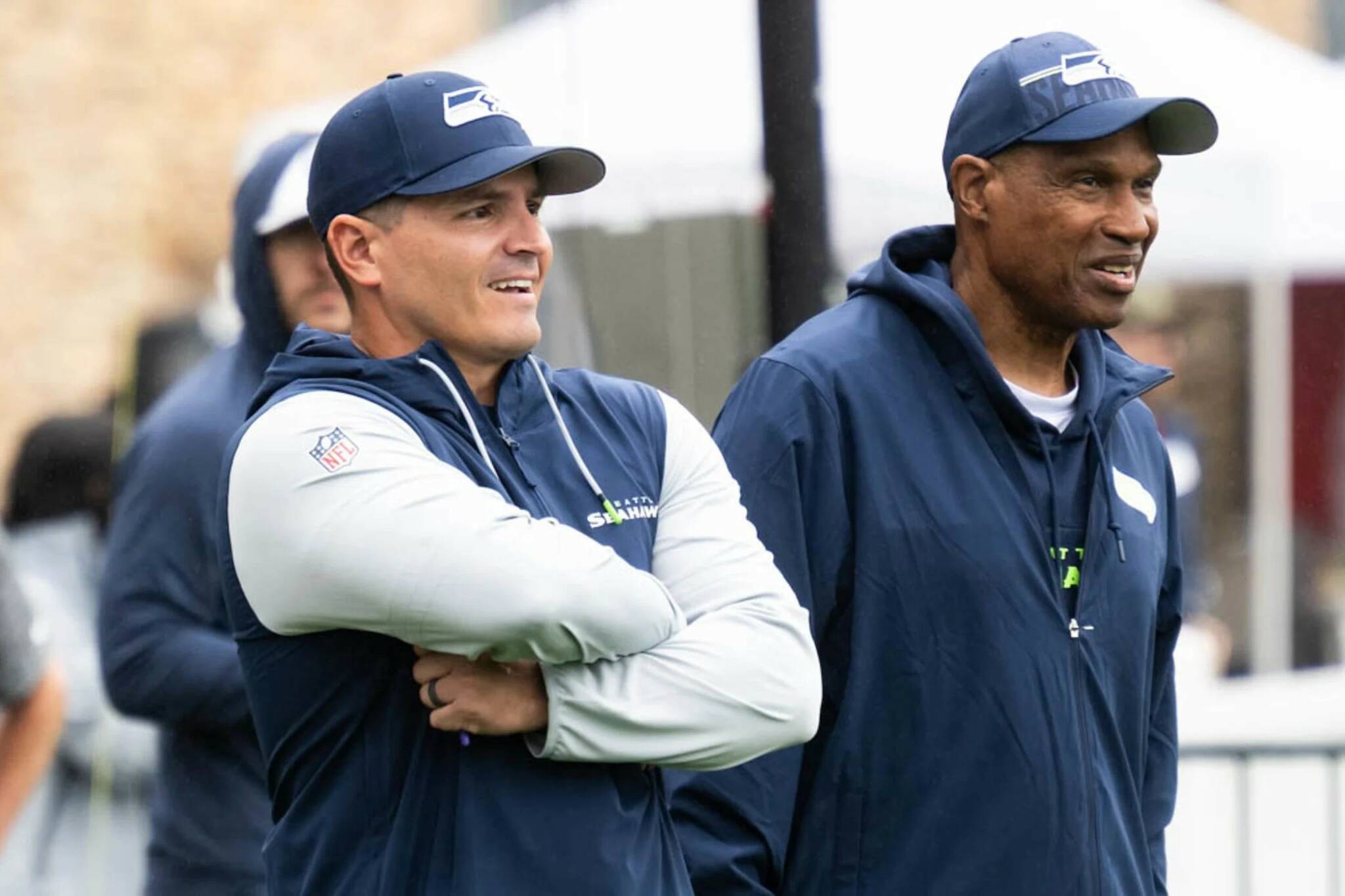 Seahawks head coach Mike Macdonald (left) stands next to assistant head coach Leslie Frazier during a practice at the Virginia Mason Athletic Center. (Photo courtesy of Rod Mar / Seattle Seahawks)