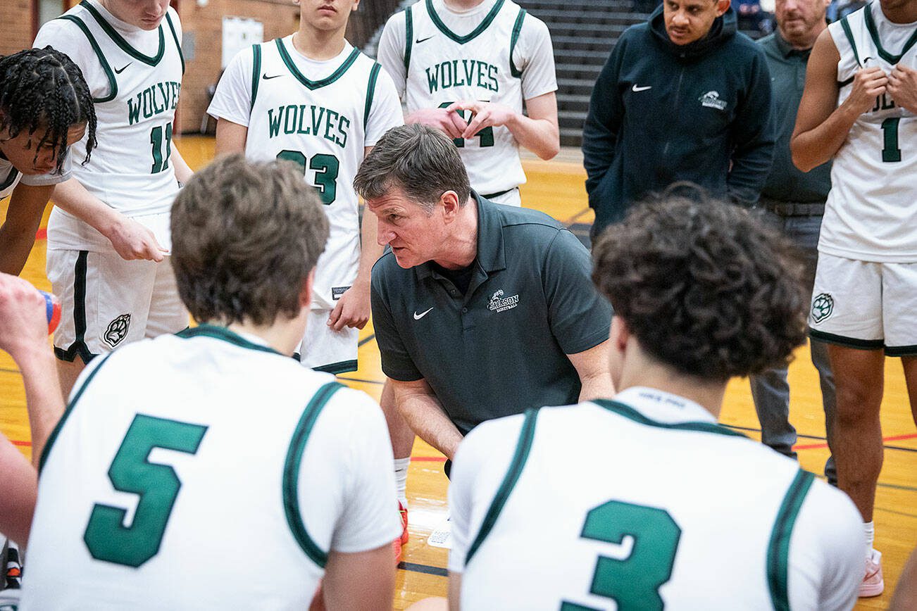 Jackson head coach Steve Johnson runs through a play with his team during a timeout on Friday, Dec. 27, 2024 in Mountlake Terrace, Washington. (Olivia Vanni / The Herald)