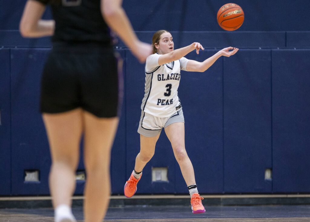 Glacier Peak’s Brynna Pukis leaps in the air to pass the ball during the game on Friday, Jan. 24, 2025 in Snohomish, Washington. (Olivia Vanni / The Herald)
