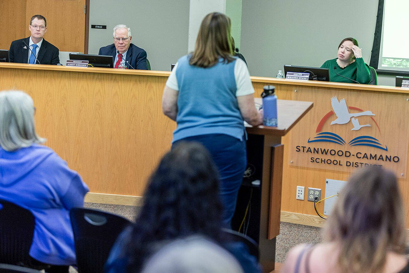 Stanwood-Camano School Board members Ryan Ovenell, Al Schreiber, and Miranda Evans, left to right,  listen to a presentation during a school board meeting on Tuesday, Feb. 18, 2025 in Stanwood, Washington. (Olivia Vanni / The Herald)