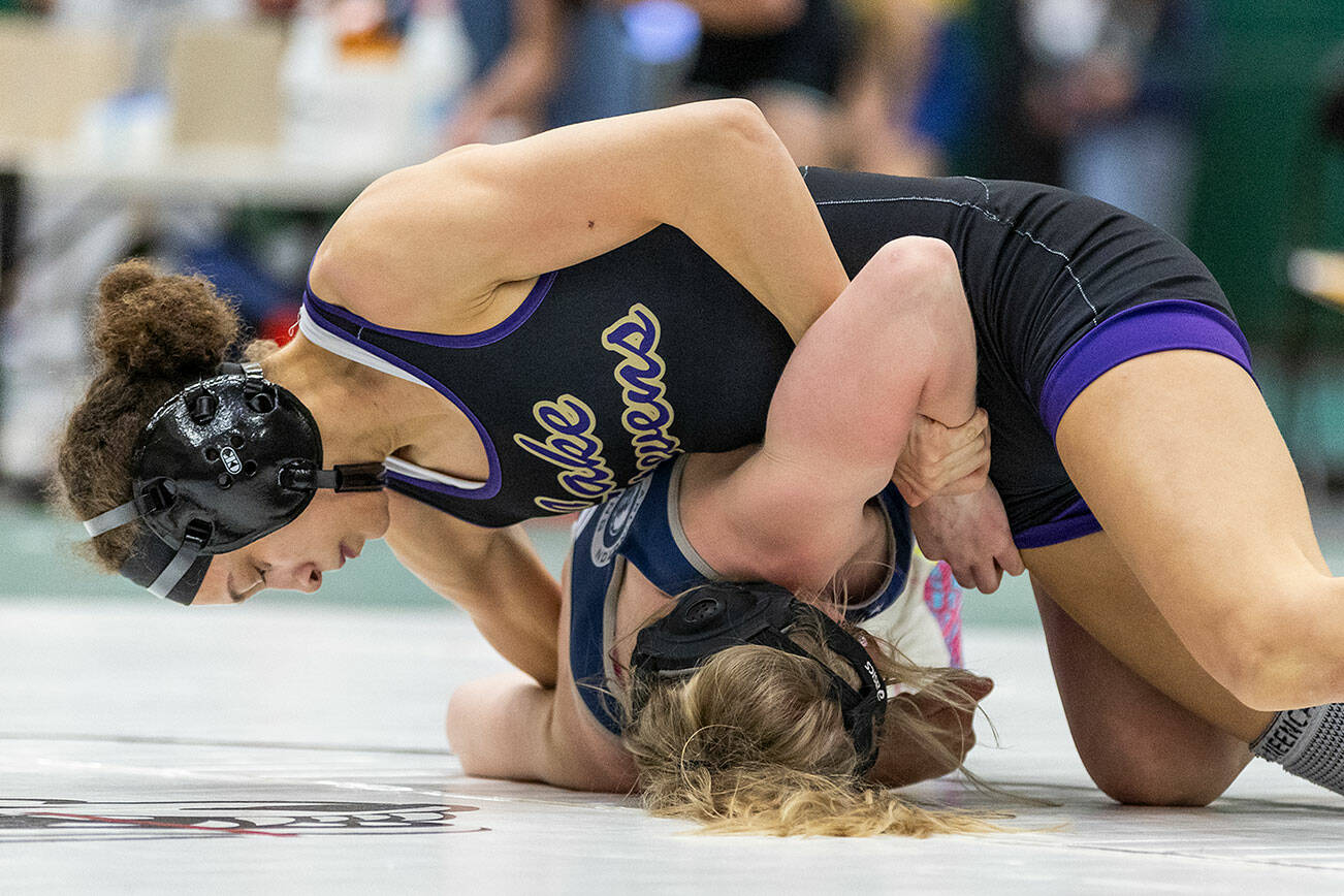 Lake Stevens’ Kamryn Mason attempts to flip Glacier Peak’s Kyla Brown onto her back during 110-pound match at the 4A girls wrestling district tournament on Friday, Feb. 7, 2025 in Mill Creek, Washington. (Olivia Vanni / The Herald)