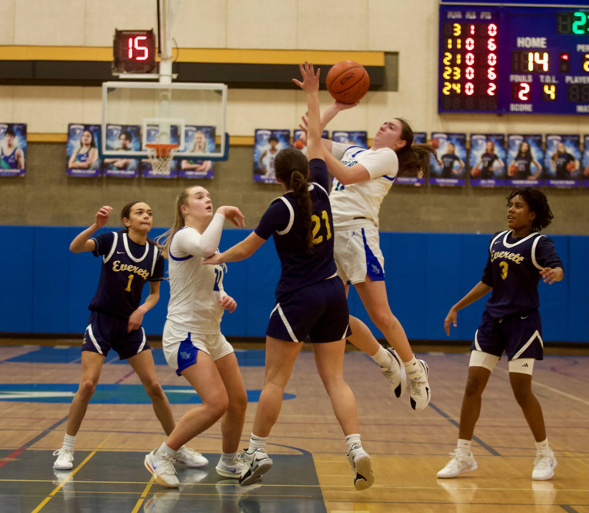 Shorewood senior Bridget Cox (11) elevates to get a shot over Everett senior Aimelie Hovde-Girard (21) in Shorewood's 41-30 win in the opening round of the District 1 3A Girls Tournament on Wednesday, Feb. 12, 2025 in Shoreline, Washington. (Joe Pohoryles / The Herald)