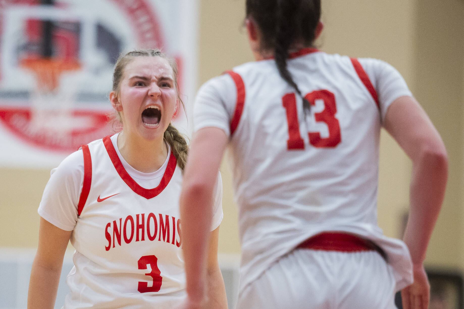 Snohomish’s Kendall Hammer yells in celebration with teammate Snohomish’s Sienna Capelli after she makes a shot and is fouled during the game on Thursday, Jan. 9, 2025 in Snohomish, Washington. (Olivia Vanni / The Herald)