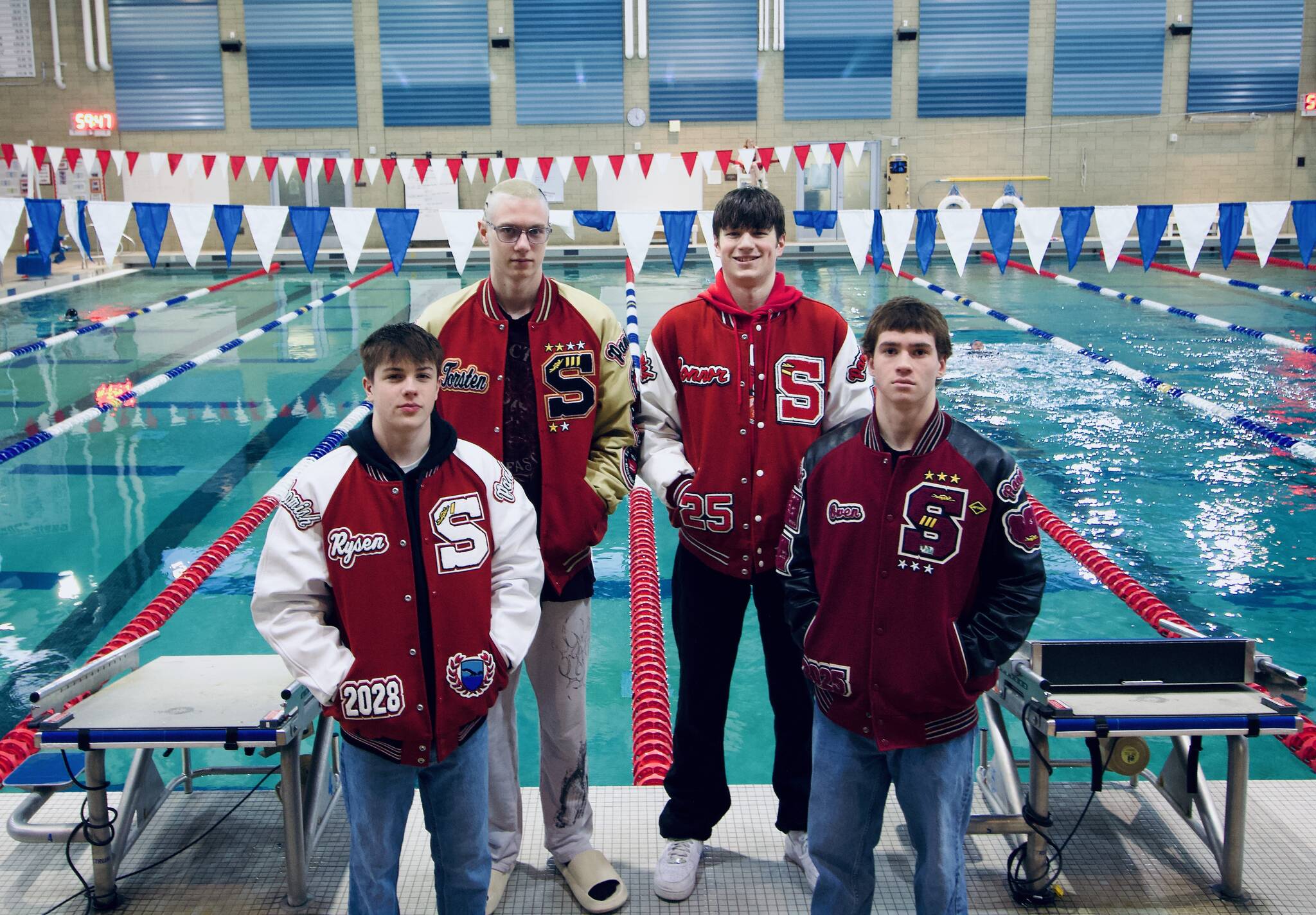 Members of the Snohomish state-champion 200- and 400-yard freestyle relay teams, from left to right, Rysen Tuomisto, Torsten Hokanson, Connor Colloton and Owen Collins stand in front of the pool at Snohomish Aquatic Center. (Photo courtesy of Anita White)