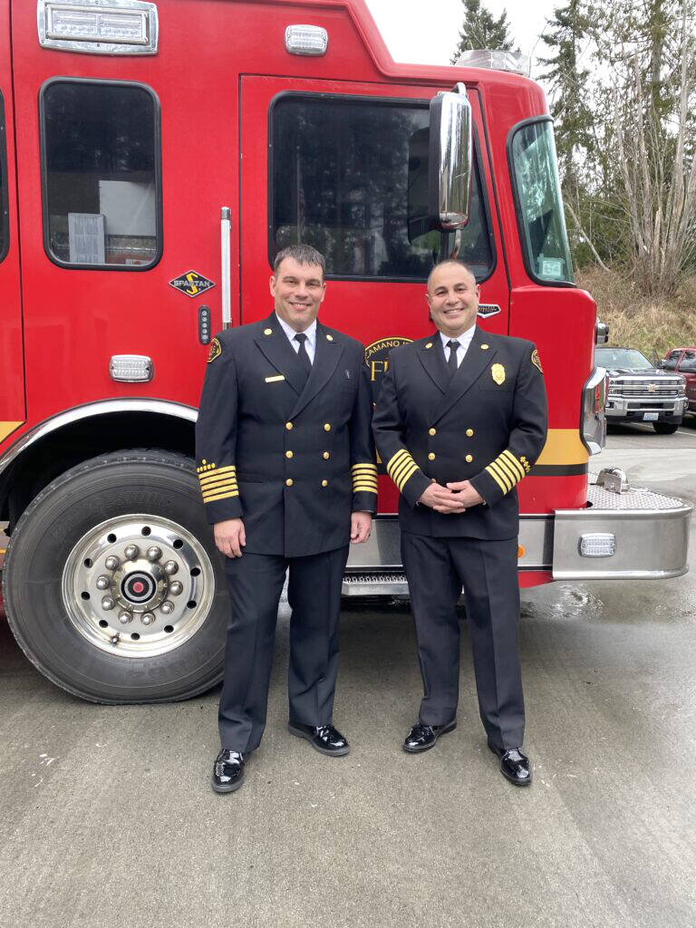 Jason Allen, the newest fire chief for Camano Island Fire & Rescue, left, poses with outgoing chief Levon Yengoyan. (Provided photo)